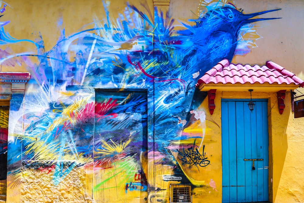 building with closed doors and bird mural