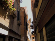 A cinematic shot of an old town alley in Dali, bathed in golden afternoon light and textured shadows.