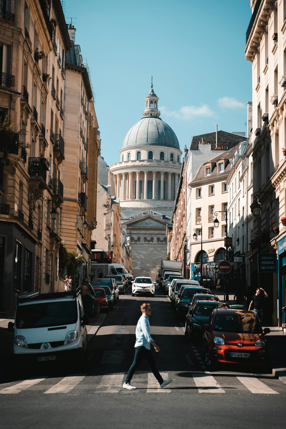 man standing on road near buildings during daytime