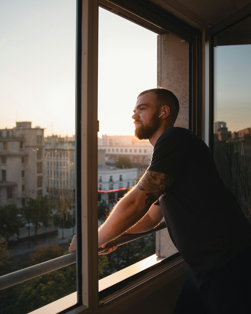 man standing beside window