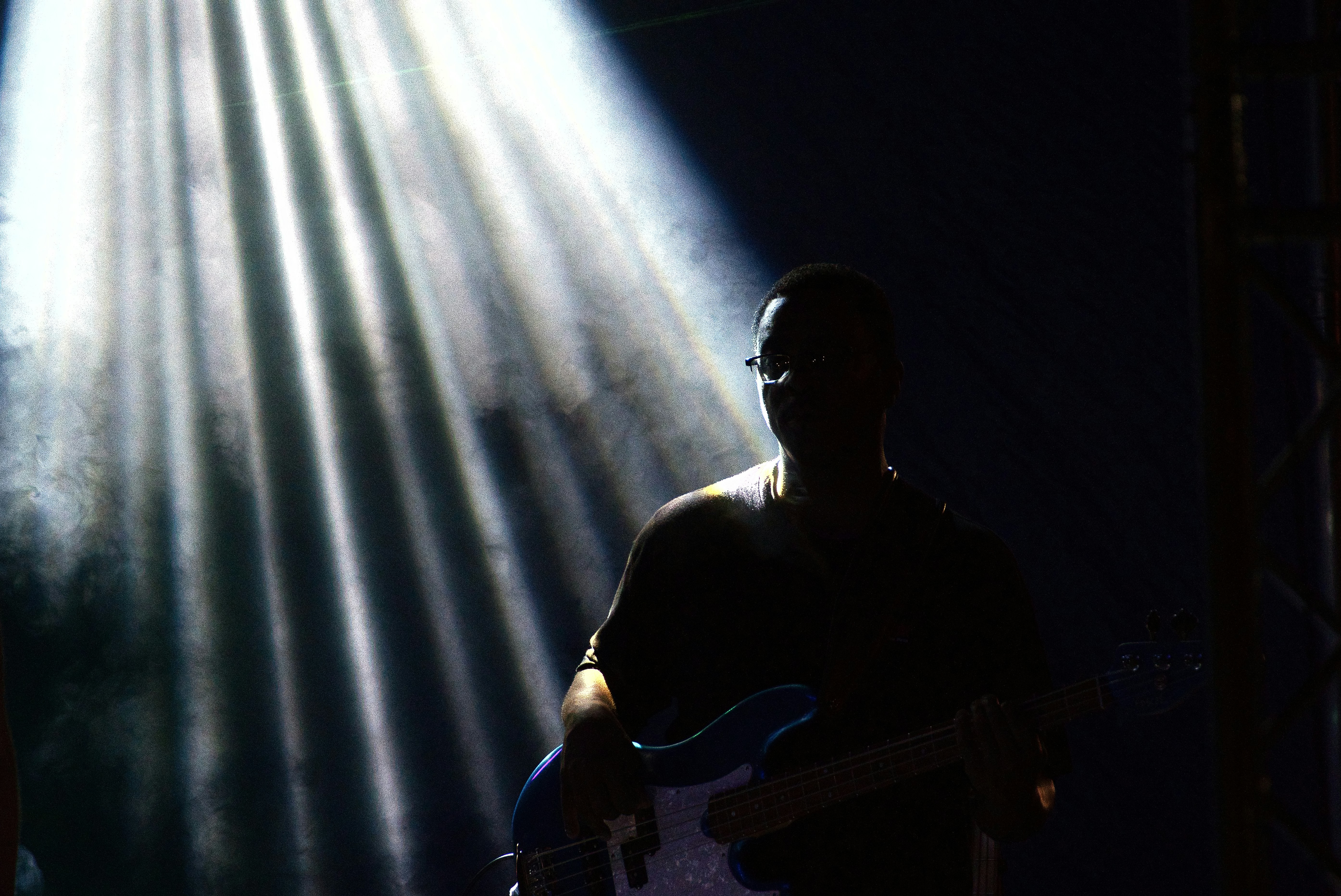Guitarist on stage with fog and spotlights