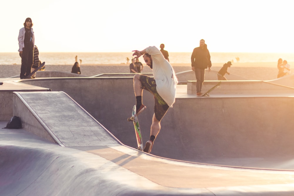 man playing skateboard during golden hour