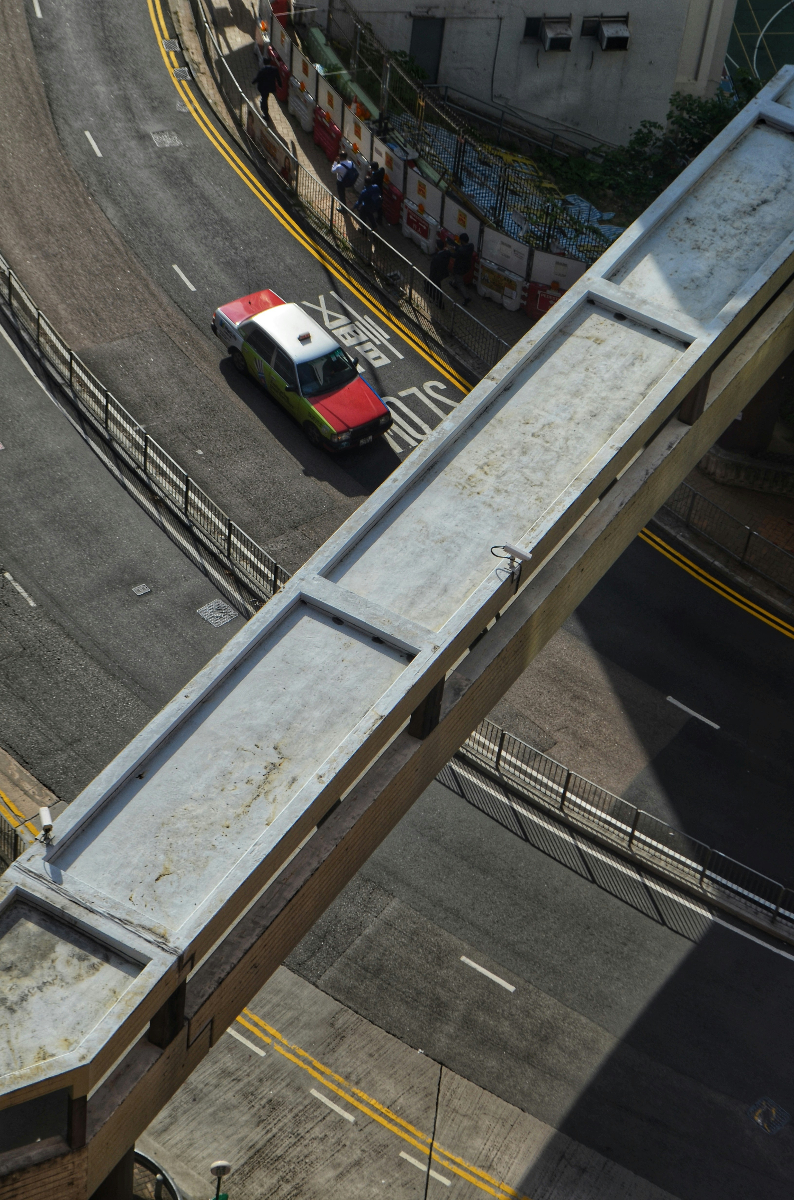 A taxi on a road in Mid-Levels, as seen from the University of Hong Kong