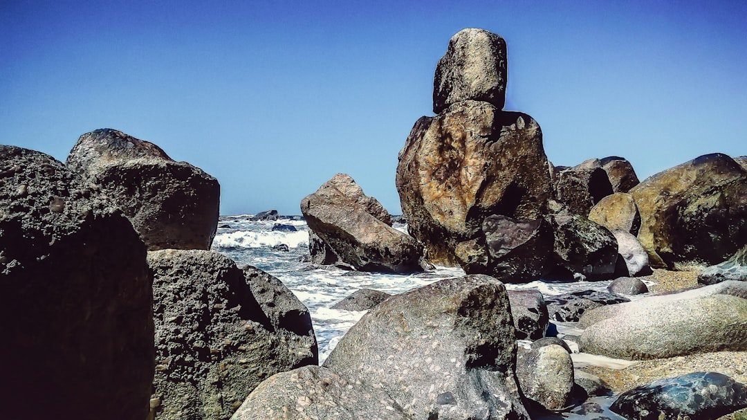 rock formations beside body of water at daytime