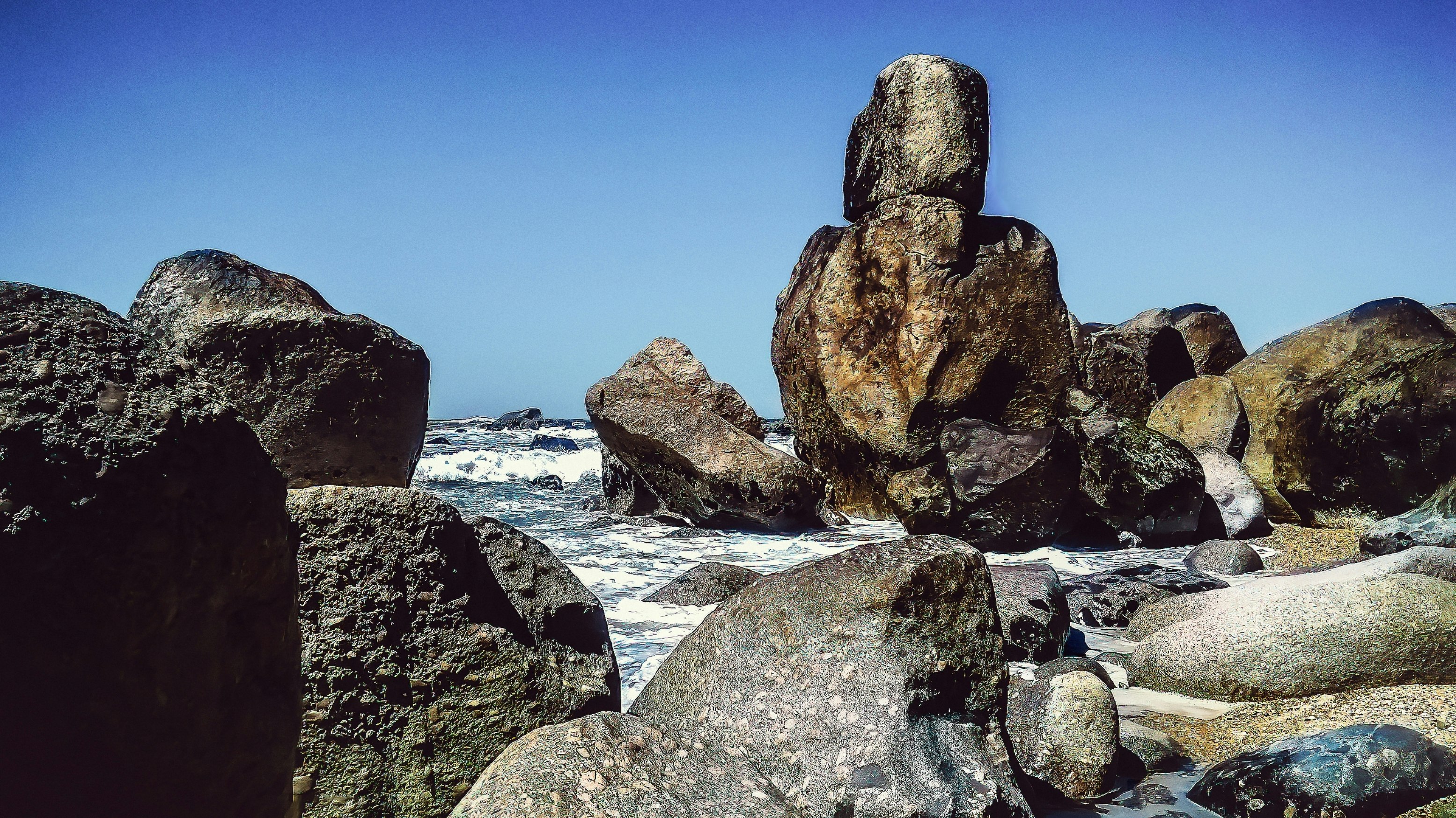 rock formations beside body of water at daytime