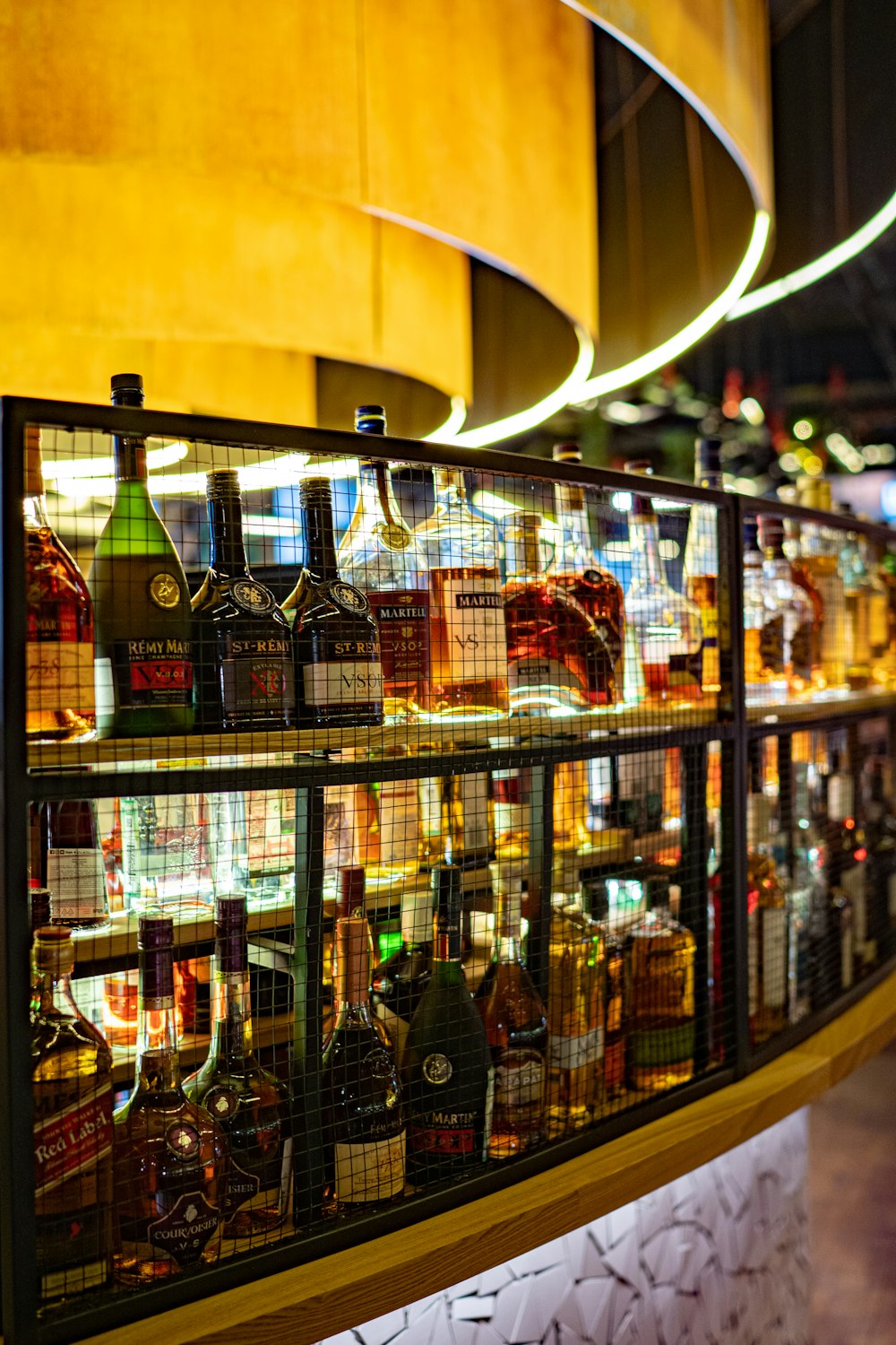 assorted wine bottles on racks indoors