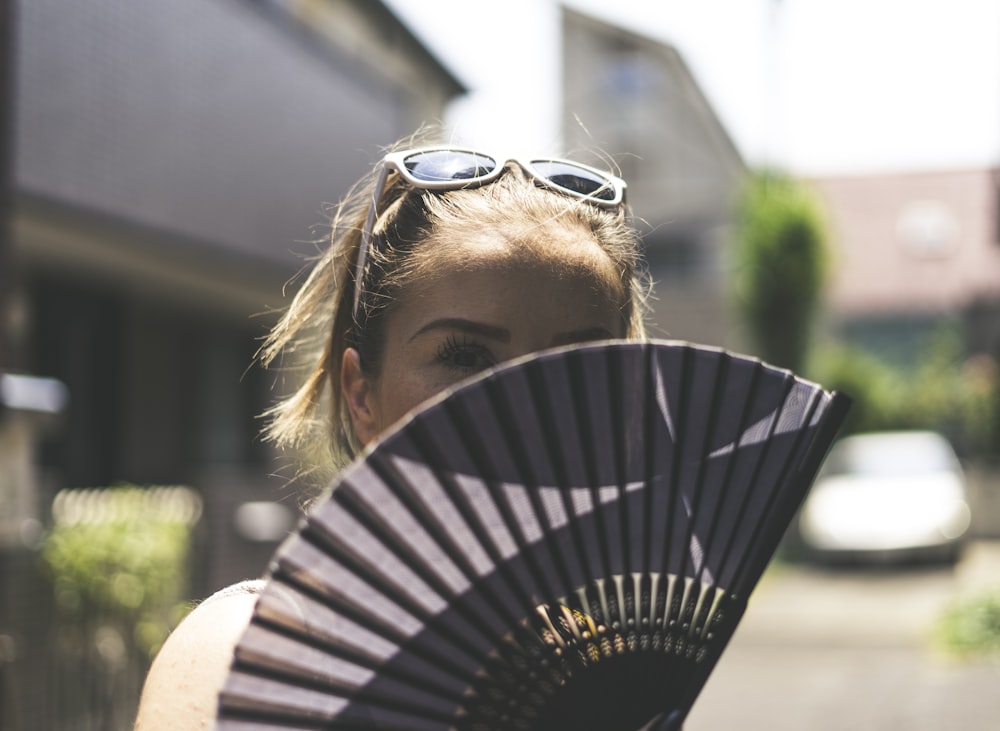 woman holding fan