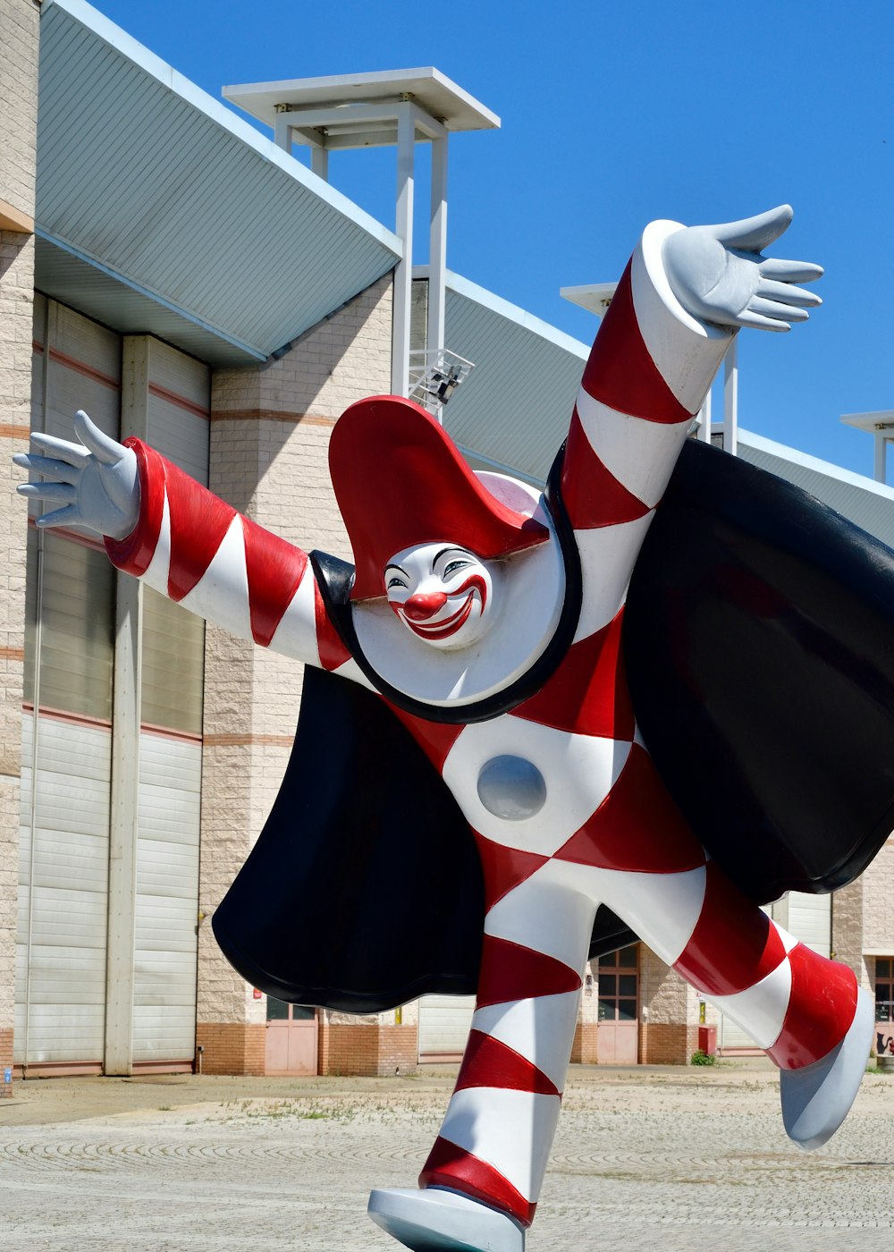 white, red, and black clown statue