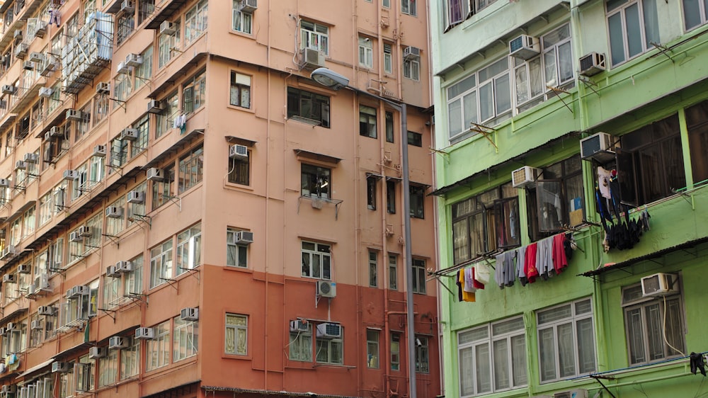 brown concrete building near green concrete building