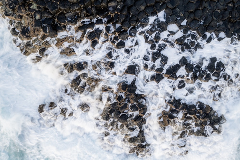 high-angle photo of shoreline and pebbles