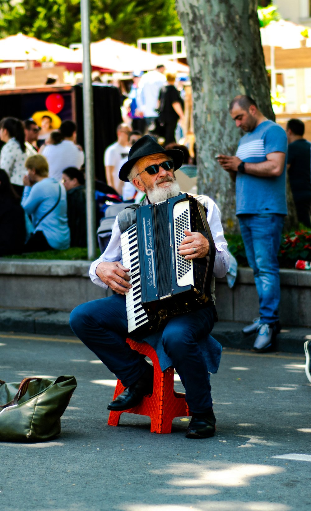 man playing harmonium