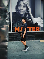 Young person walking city streets wearing vibrant streetwear sneakers