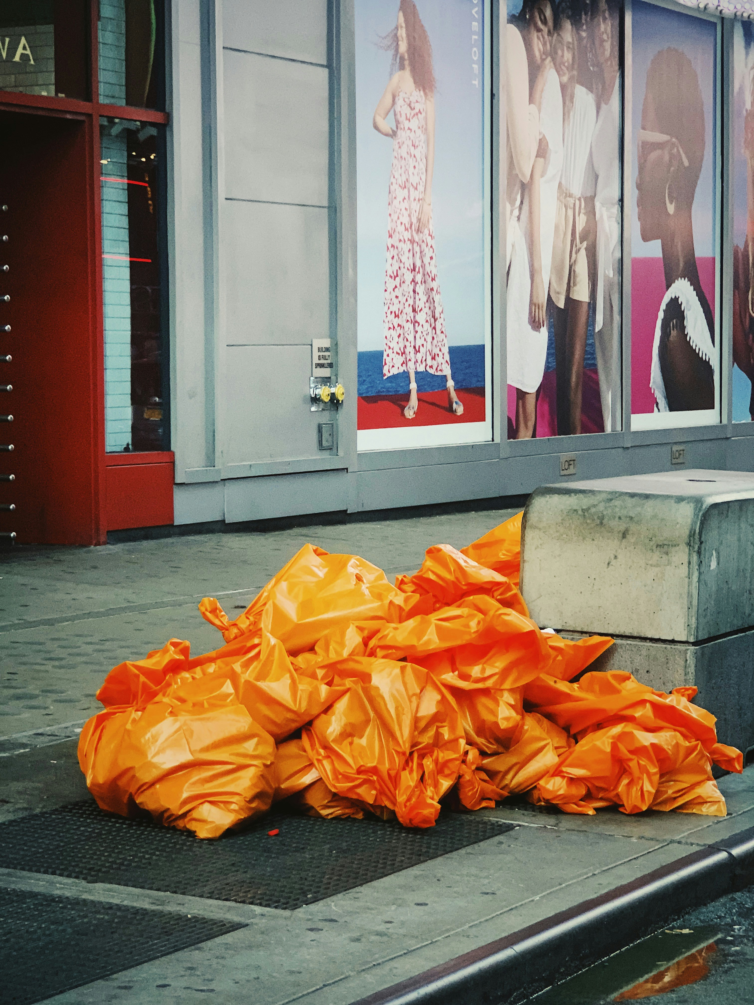Orange garbage bags beside corner photo Free Person Image on Unsplash