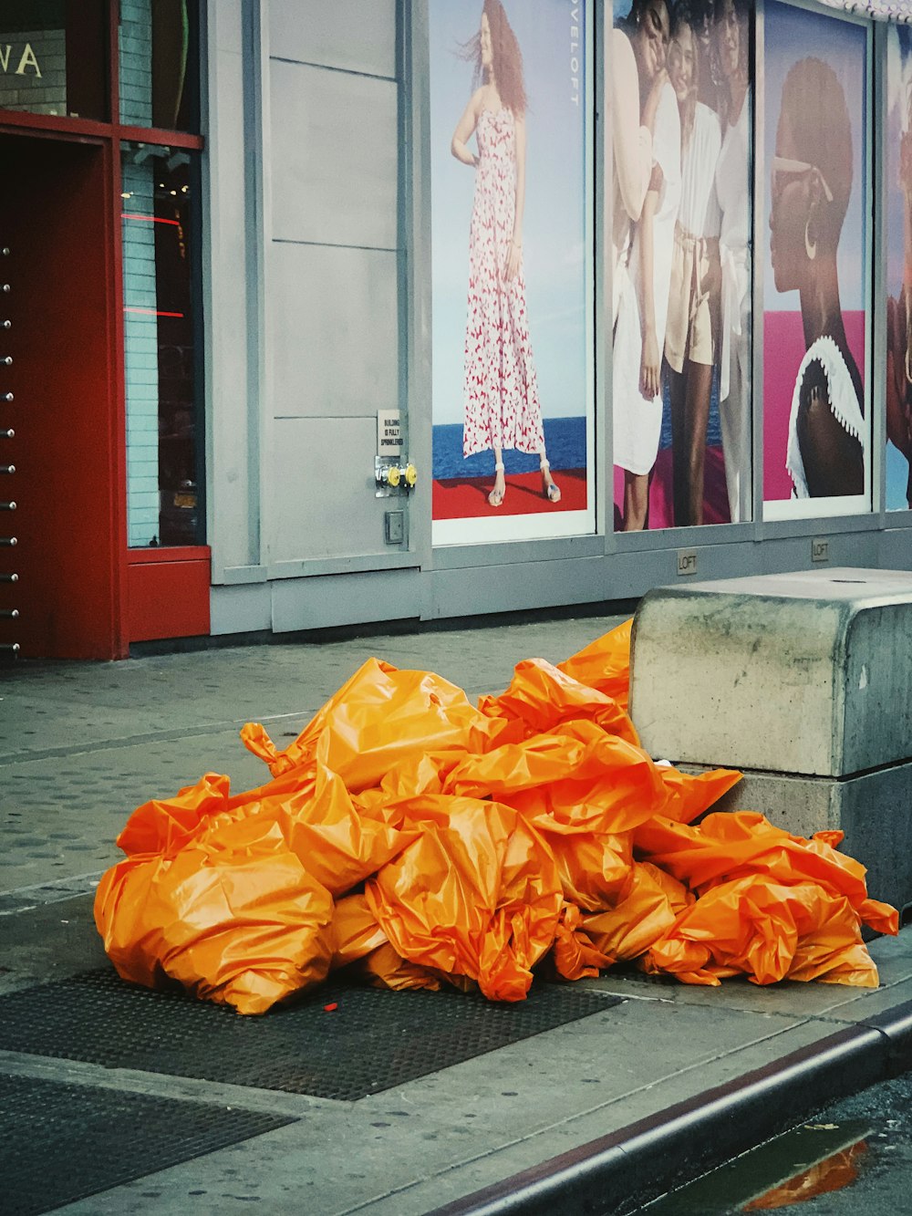 orange garbage bags beside corner