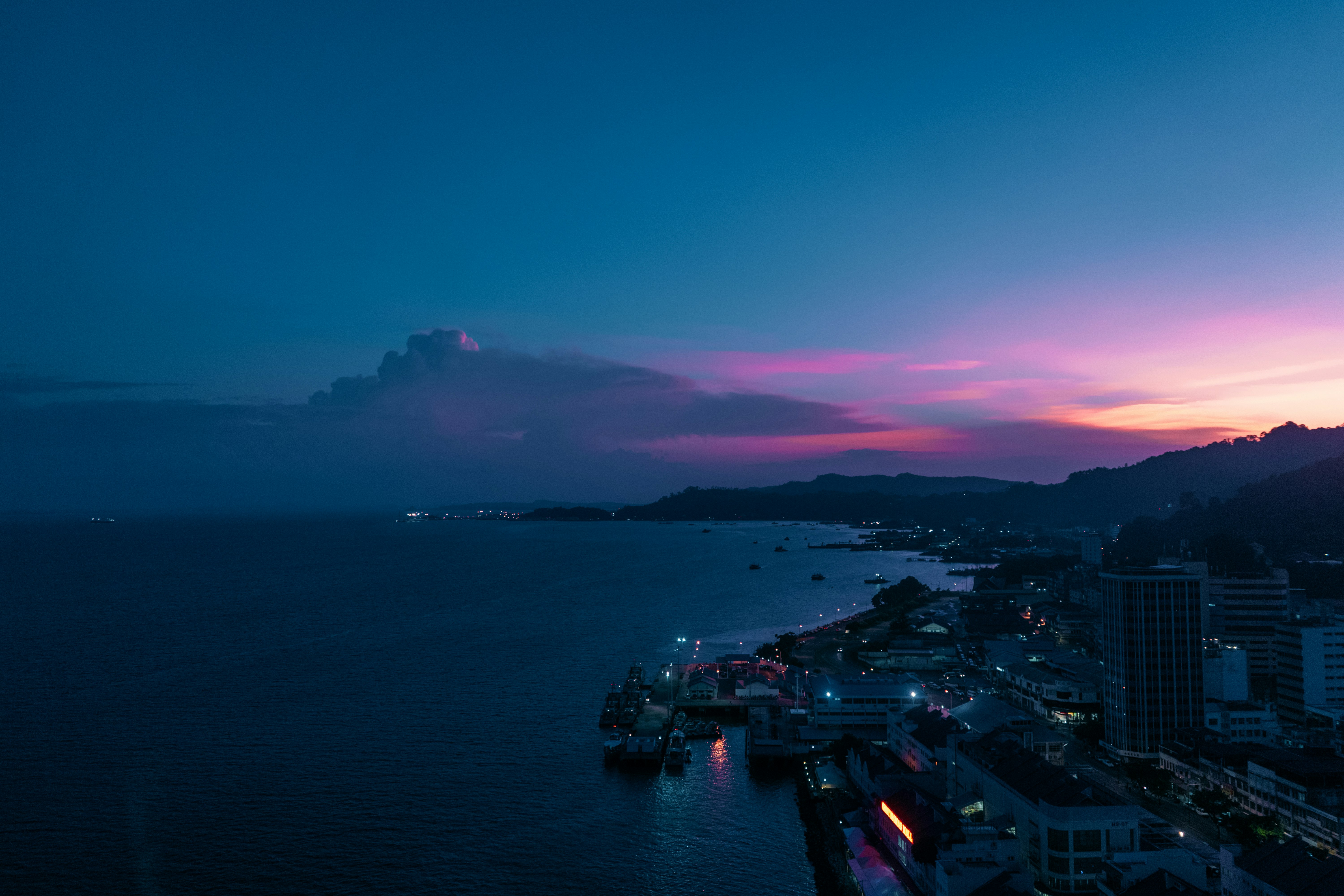 cityscape facing ocean during golden hour