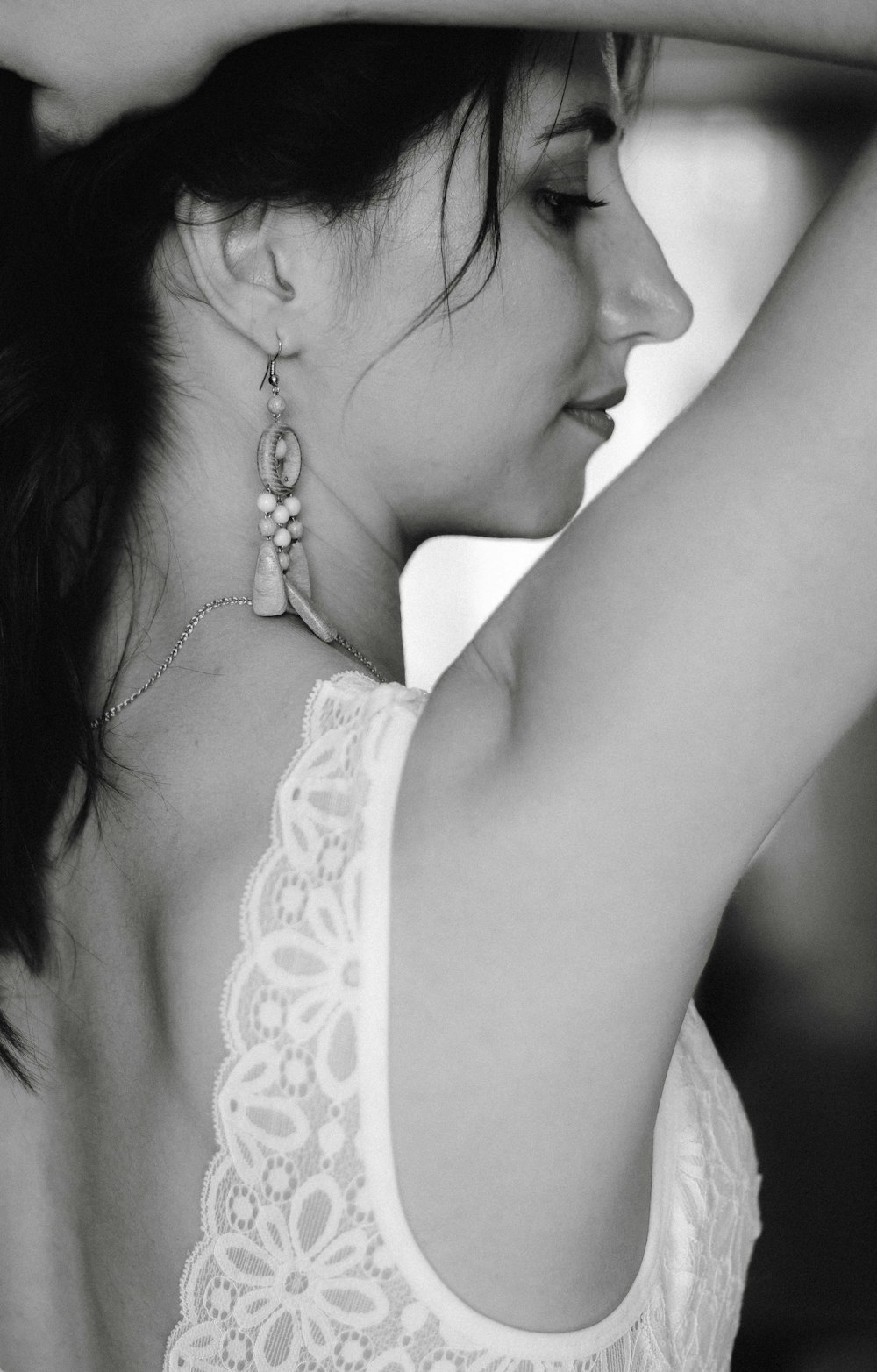 grayscale photography of woman wearing white top