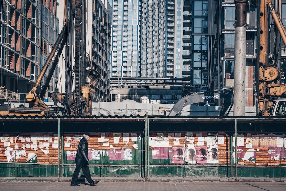 man walking on sidewalk during daytime