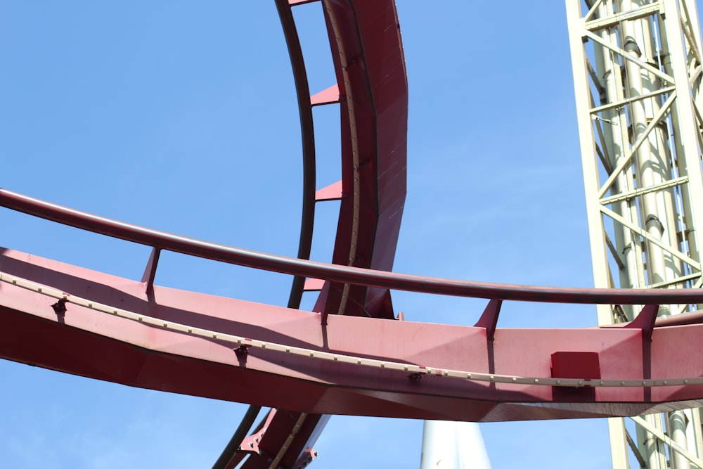 red roller coaster track during day