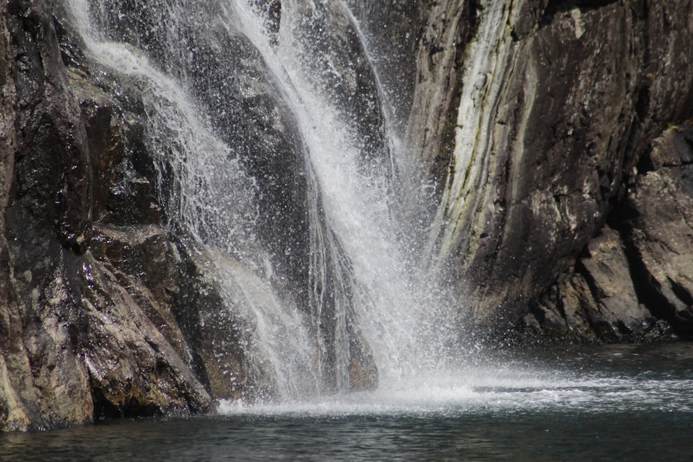 waterfalls beside mountian