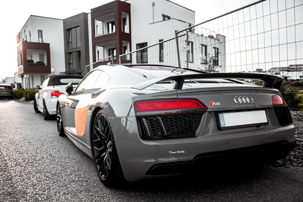 grey Audi R8 coupe parked near fence