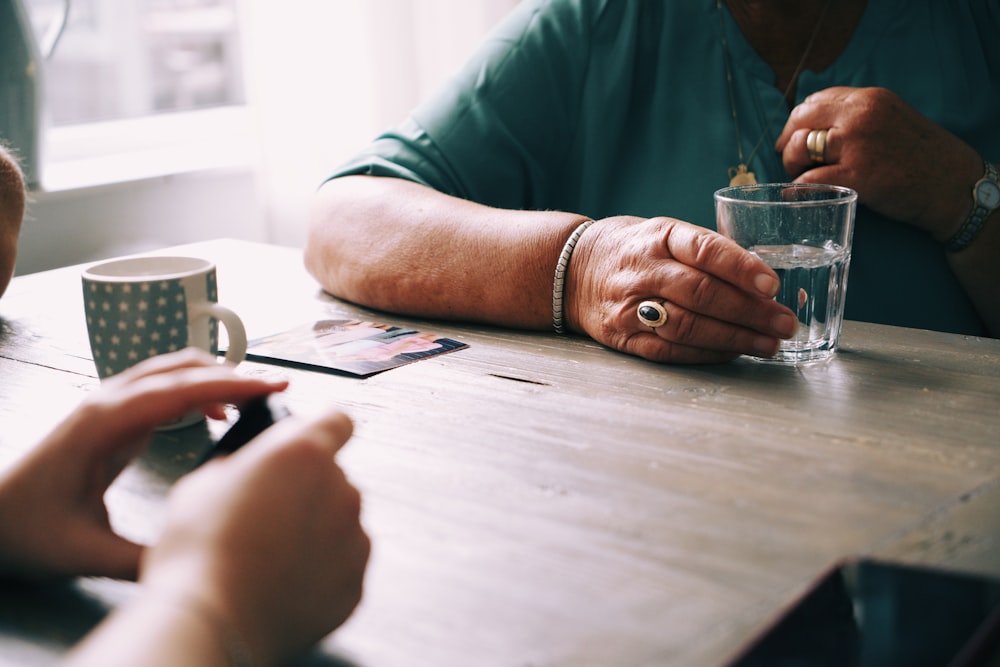 person holding drinking glasses