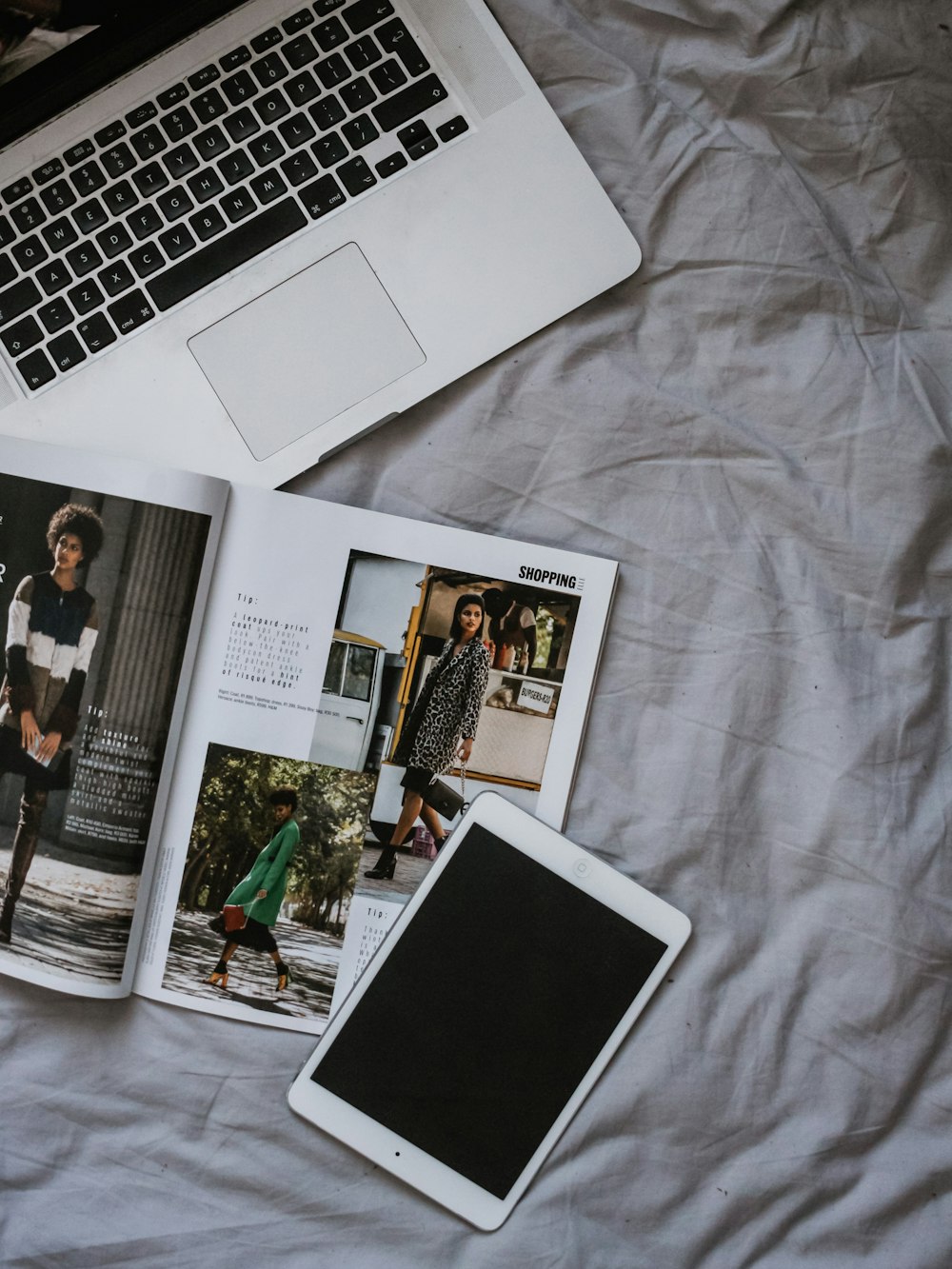 white iPad on bed