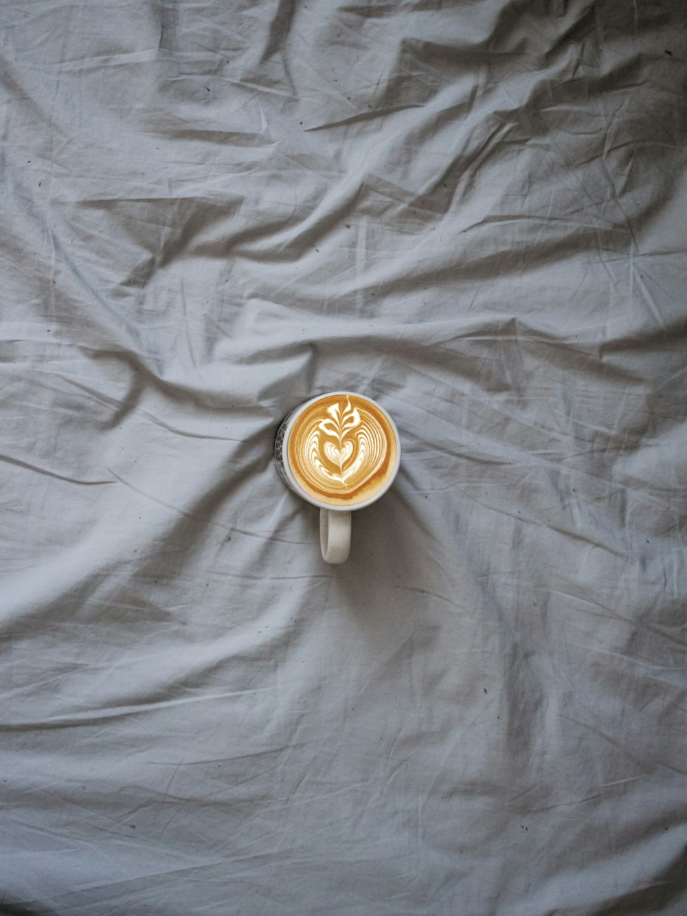 white ceramic mug on gray surface