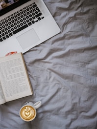 Cozy workspace with books, a laptop, and a coffee cup symbolizing indie publishing.