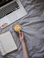 A serene coffee break scene with a laptop and productivity book nearby.