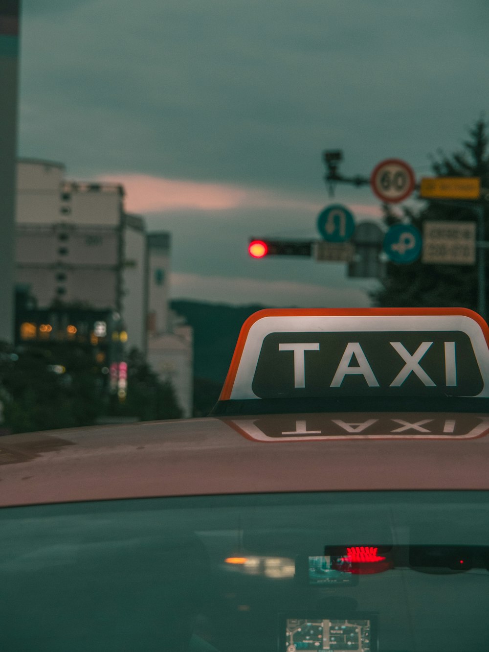 gray Taxi on road showing stop traffic light sign