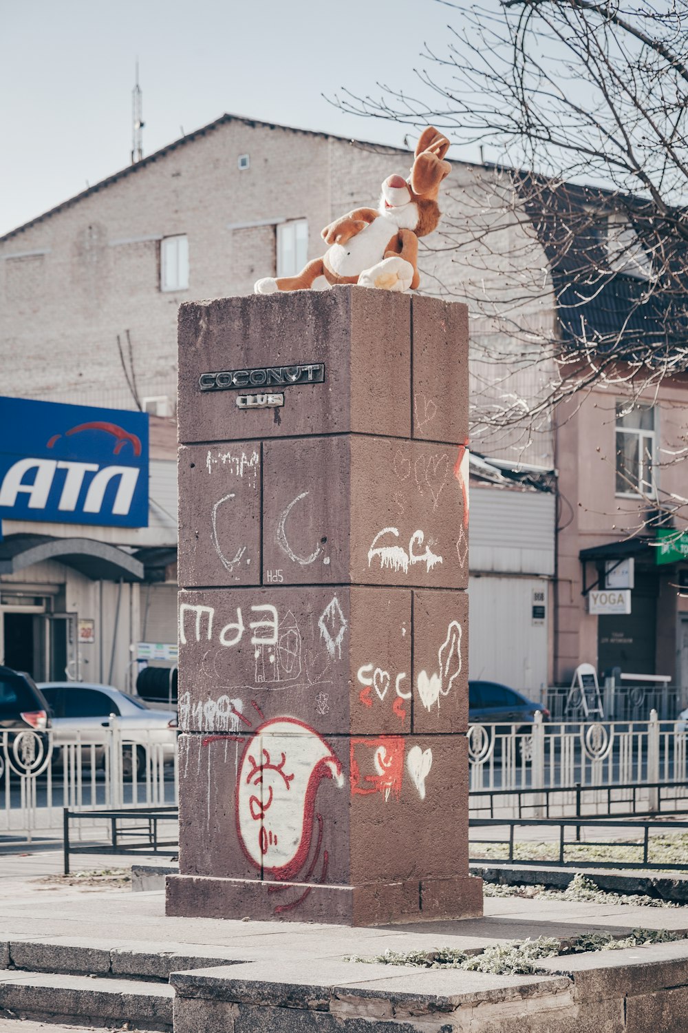 brown rabbit plush toy on brown concrete pedestal