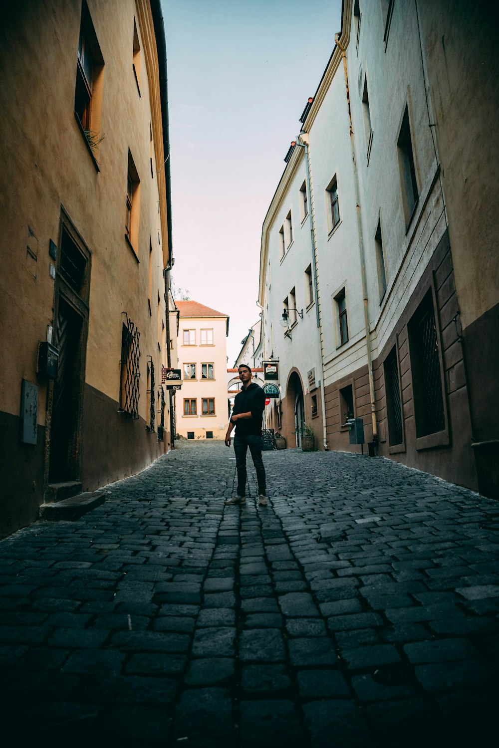 man standing between building