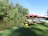 A serene view of canoes lined up along a riverbank.