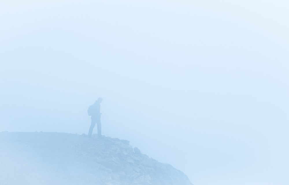 man on a foggy cliff