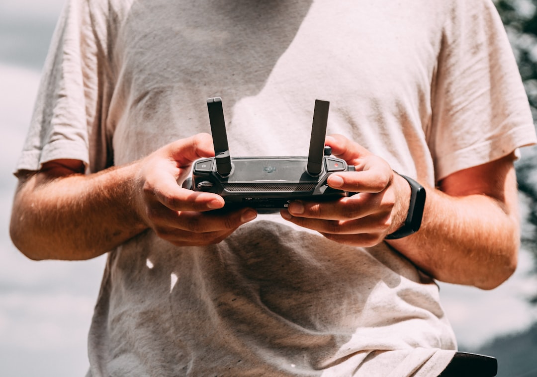 person holding black RC controller