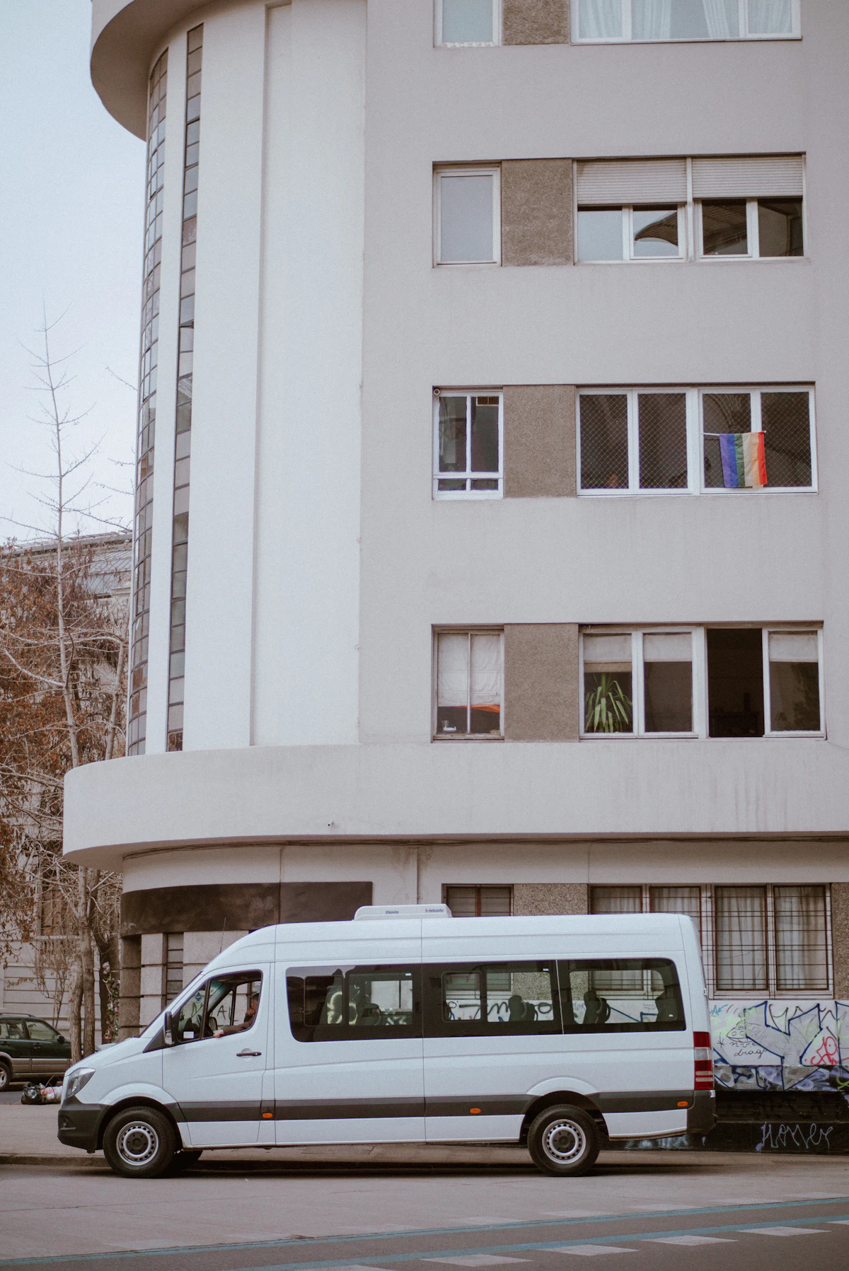 White van pulling up outside a building