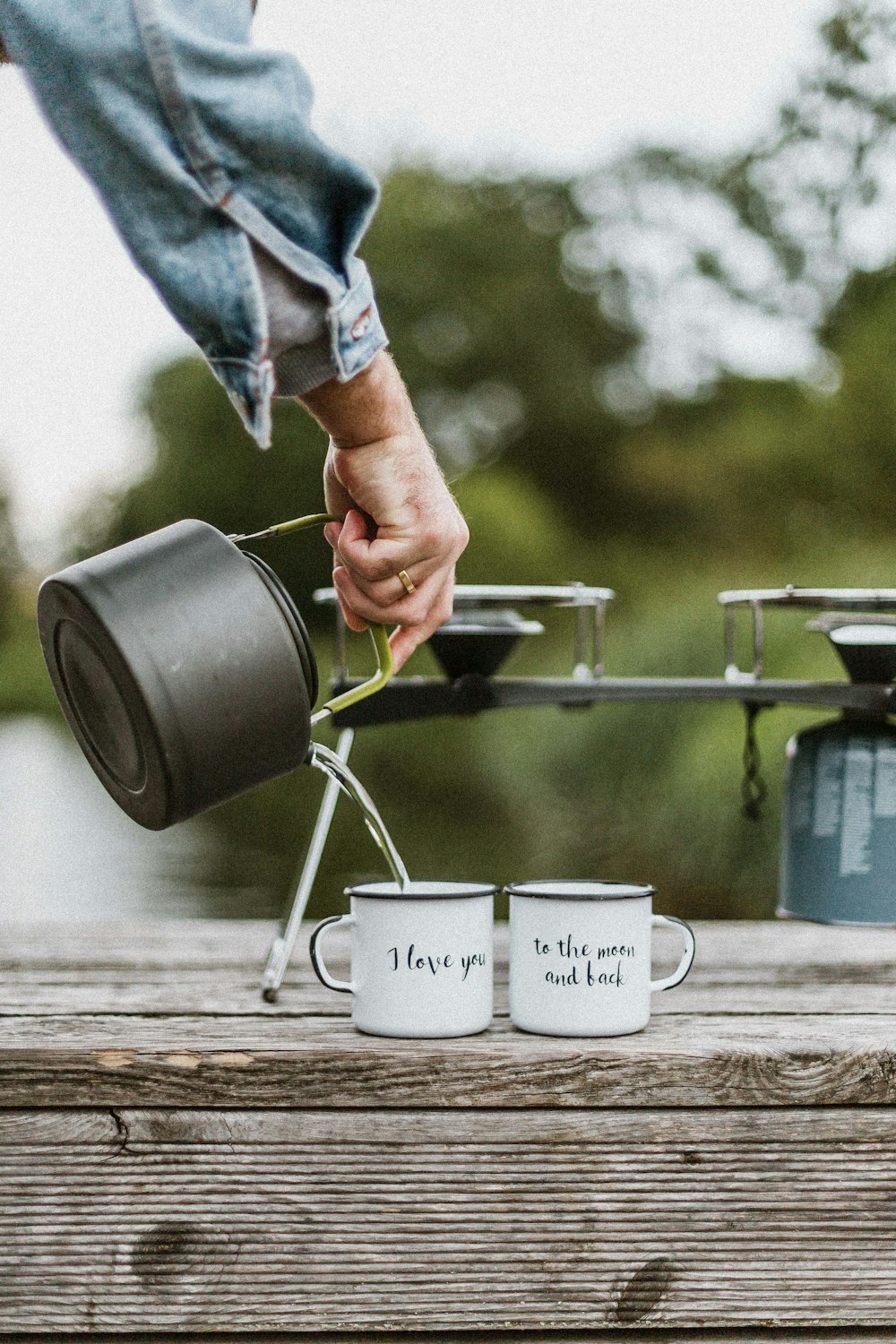 person pouring liquid to mug