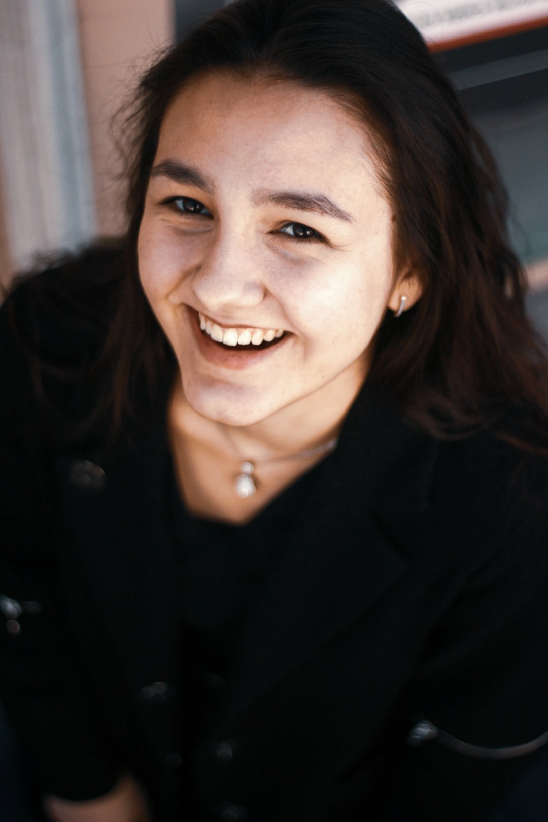 woman in black blazer smiling