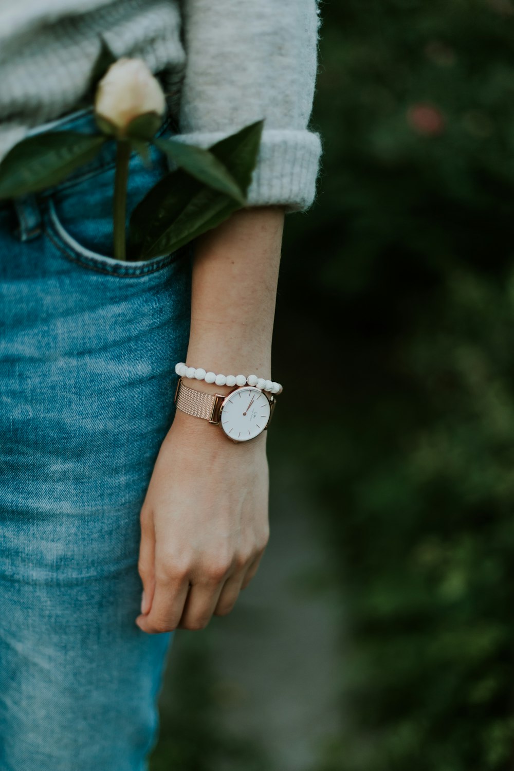 woman wearing gold-colored analog watch