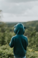 A playful scene with kids in muted green sweatshirts.