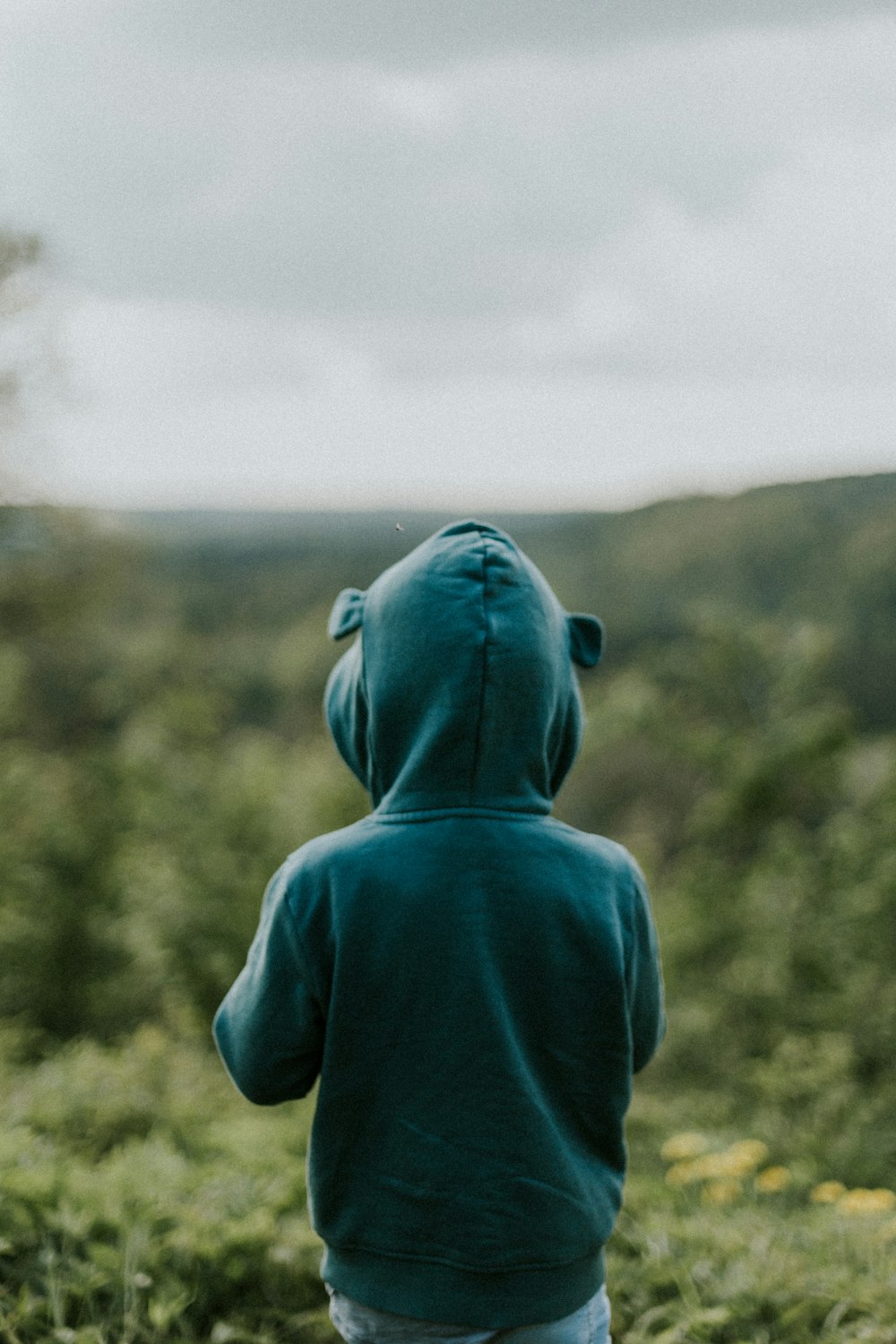 kid wearing green hoodie close-up photography