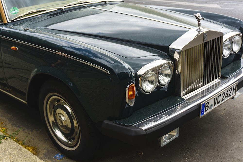 classic black Rolls Royce car parked at roadside