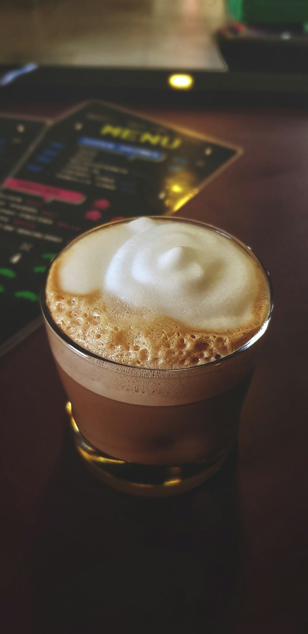 coffee with foam on glass cup