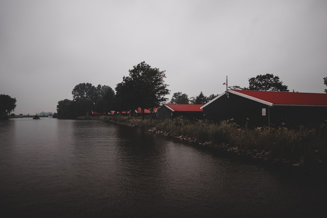 red roofed house by the river