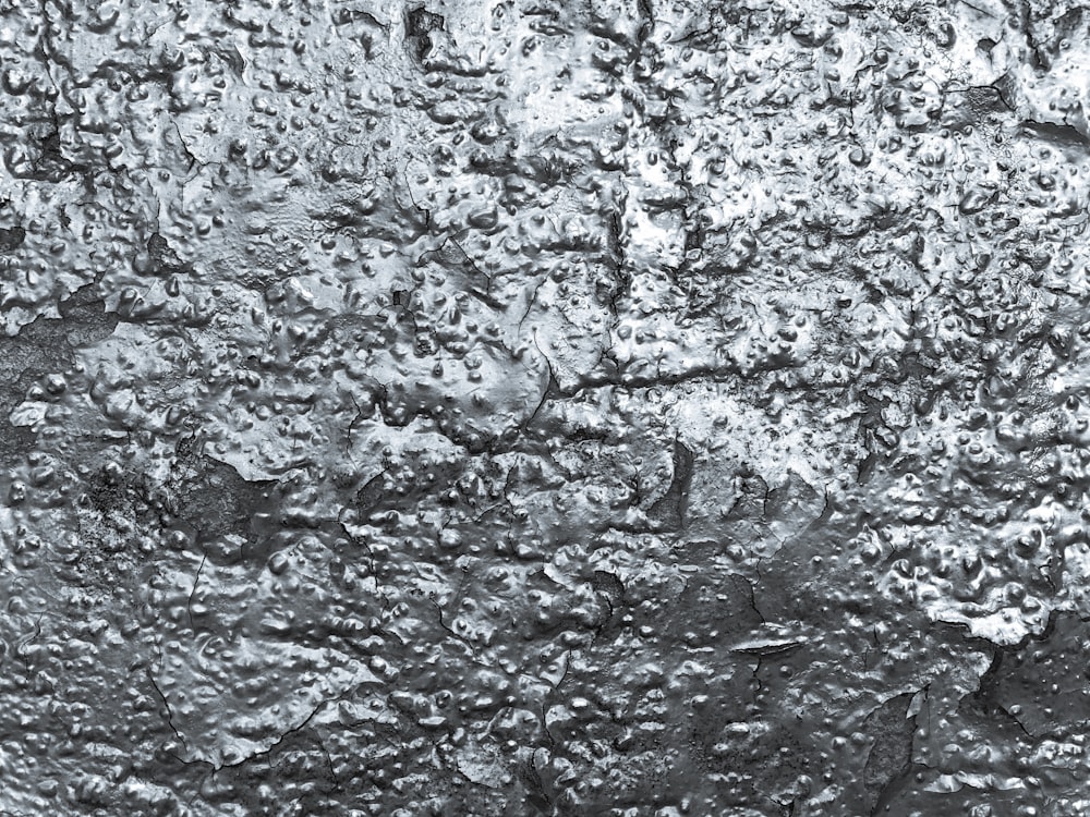 a black and white photo of the surface of a wall