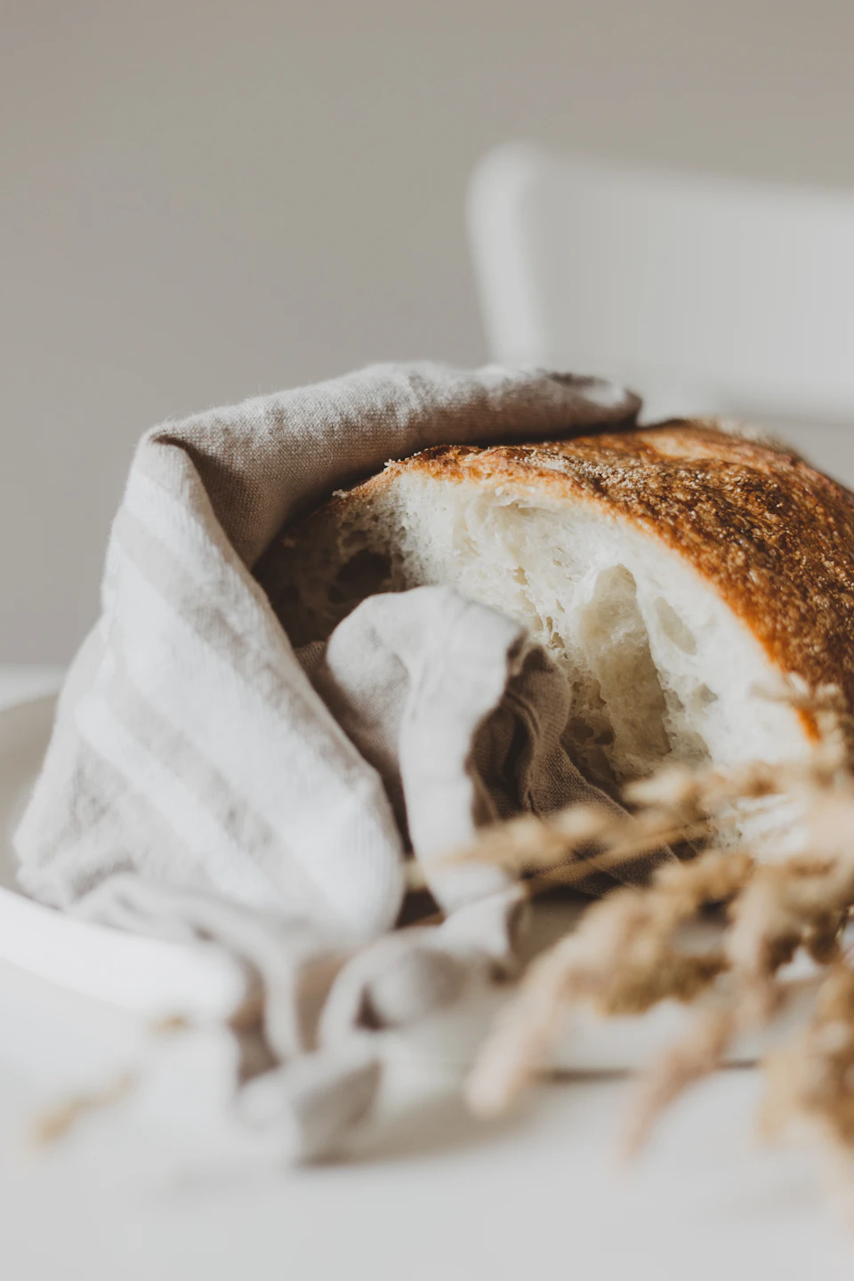 White plate with toasted slice of bread on it, resting on a tablecloth