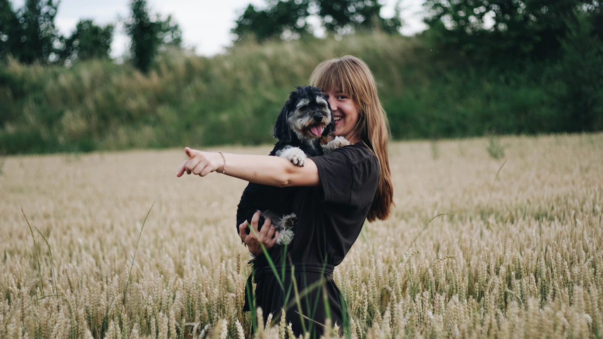 A woman and a dog spending time together in a grassy field.