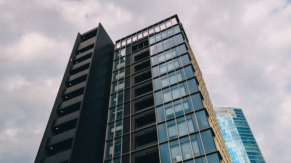 blue and brown high rise building under grey cloudy sky