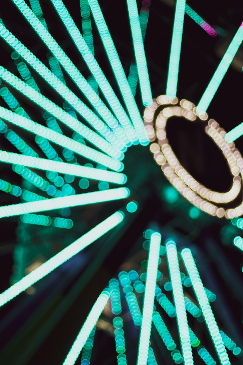 a close up of a ferris wheel at night