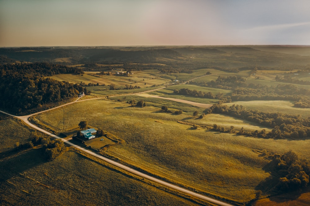 aerial photography of open field and green trees during daytime